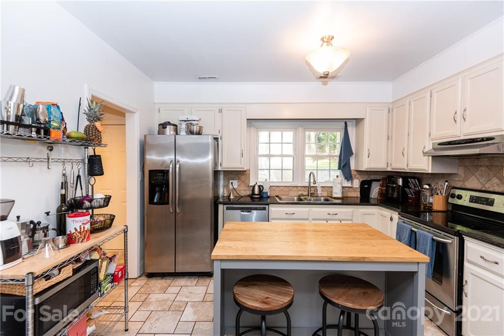 5810 Brookhaven Road Charlotte, NC 28210 - Photo 8 of 16 a kitchen with stainless steel appliances granite countertop a sink a stove and a refrigerator