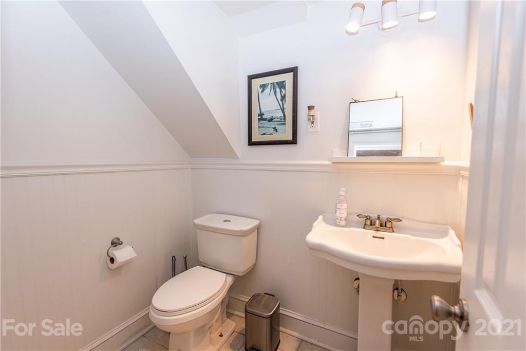 5810 Brookhaven Road Charlotte, NC 28210 - Photo 10 of 16 a bathroom with a toilet sink and mirror
