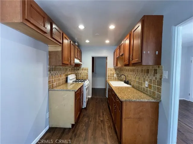 a kitchen with a sink stove and cabinets