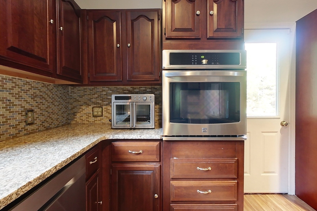 55 Gilchrist Road Townsend, MA 01469 - Photo 4 of 42 a kitchen with granite countertop cabinets stainless steel appliances and a counter space