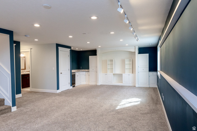 434 Cardon Ridge Drive Smithfield, UT 84335 - Photo 37 of 59 basement entertaining room with light colored carpet, rail lighting, and beverage cooler