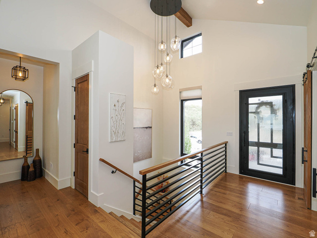 3167 South Mapleton Estates Drive Mapleton, UT 84664 - Photo 4 of 42 Foyer entrance with hardwood / wood-style flooring, arched walkways, a barn door, and lofted ceiling