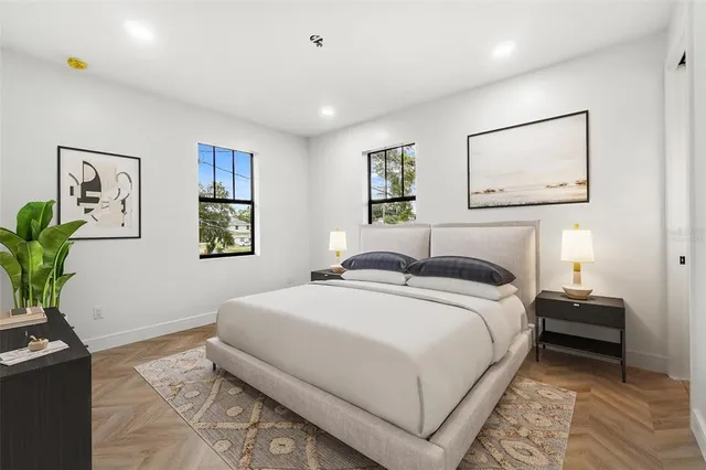 a bedroom with a bed and a potted plant