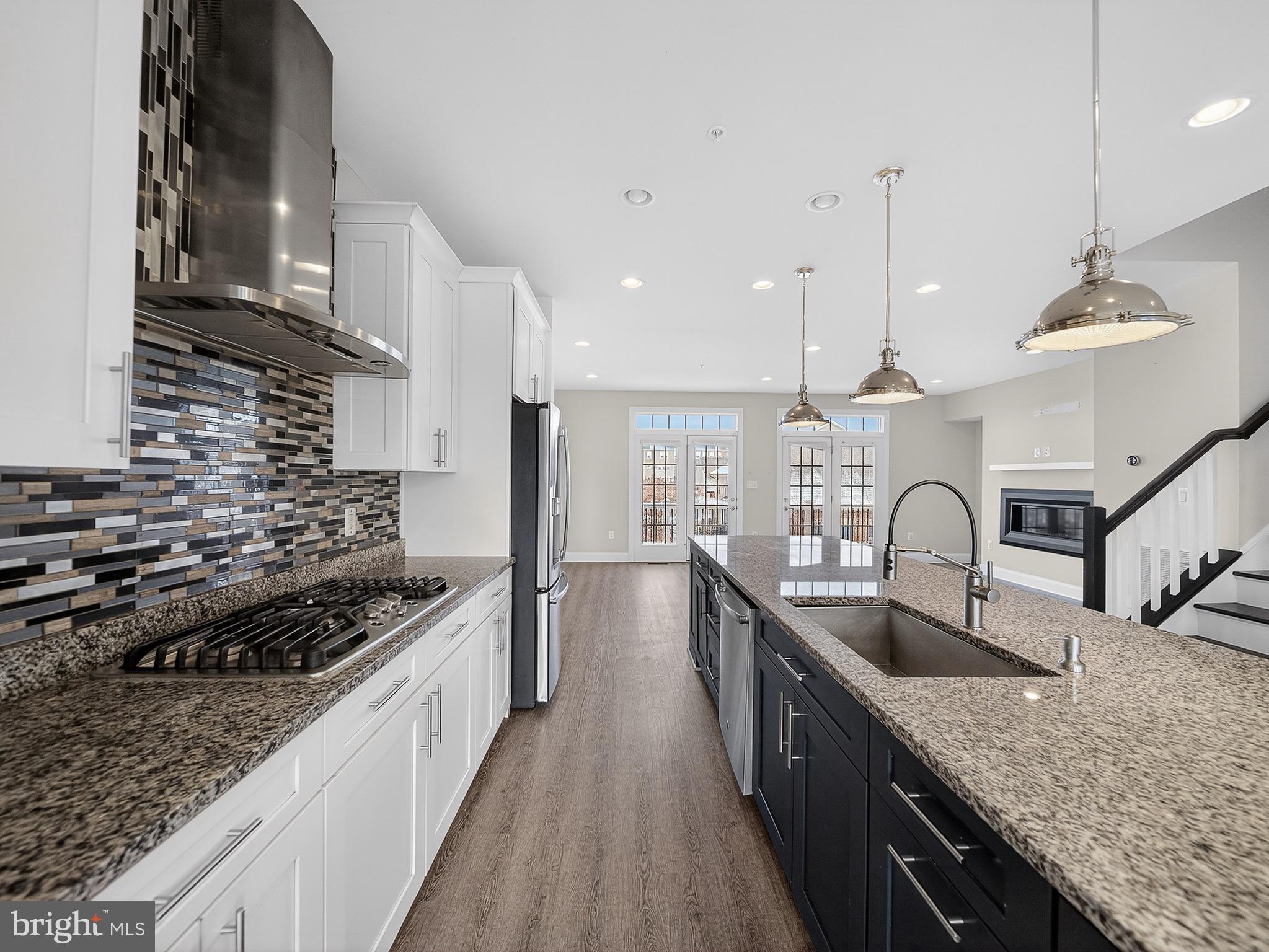 2914 Middleham Court Hanover, MD 21076 - Photo 11 of 50 a kitchen with stainless steel appliances granite countertop a sink a stove top oven a counter space and cabinets