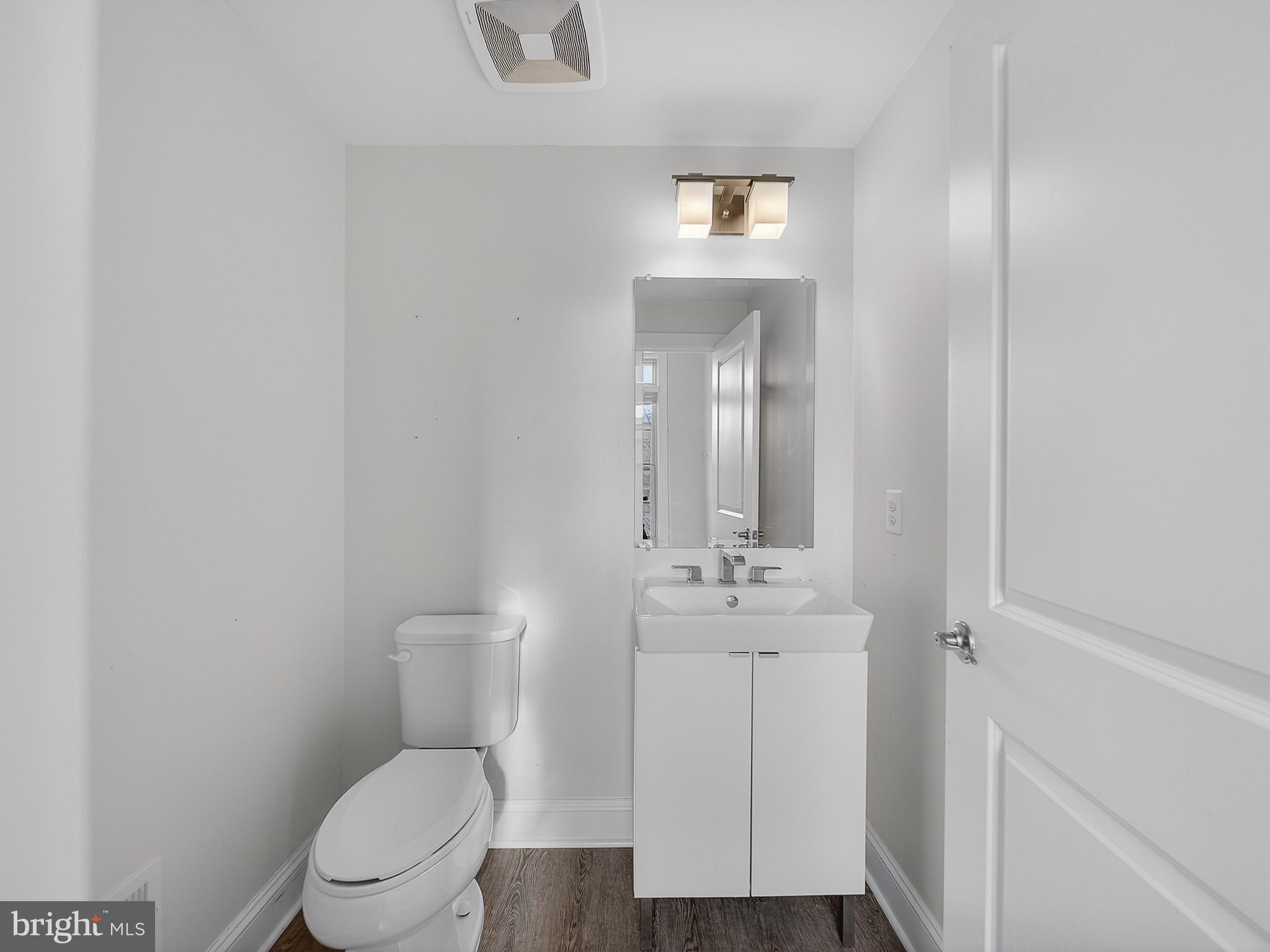 2914 Middleham Court Hanover, MD 21076 - Photo 16 of 50 a bathroom with a toilet a sink and mirror