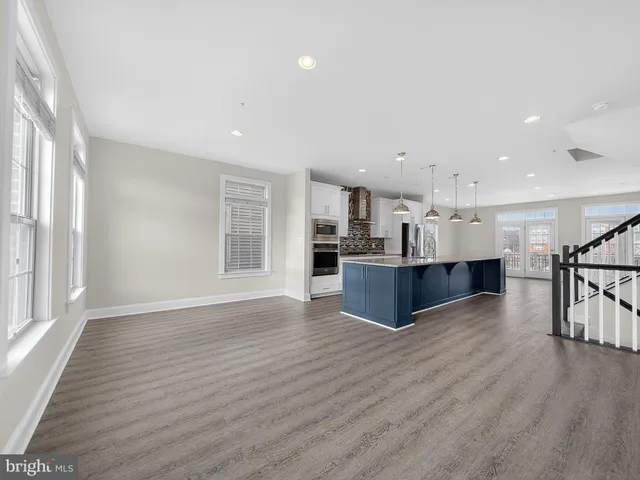 a view of kitchen with wooden floor and windows