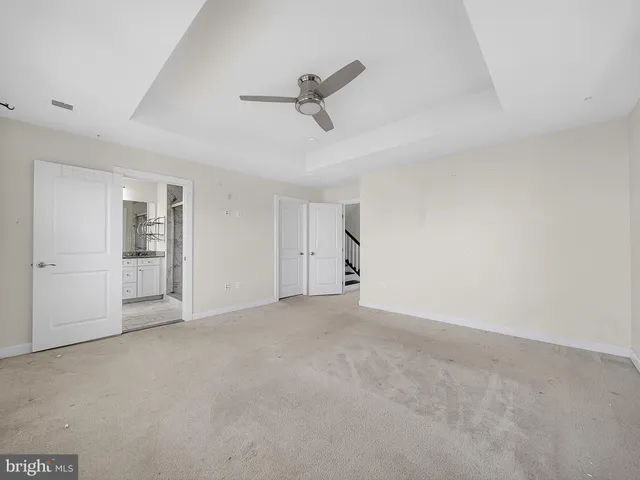 a view of an empty room with a ceiling fan