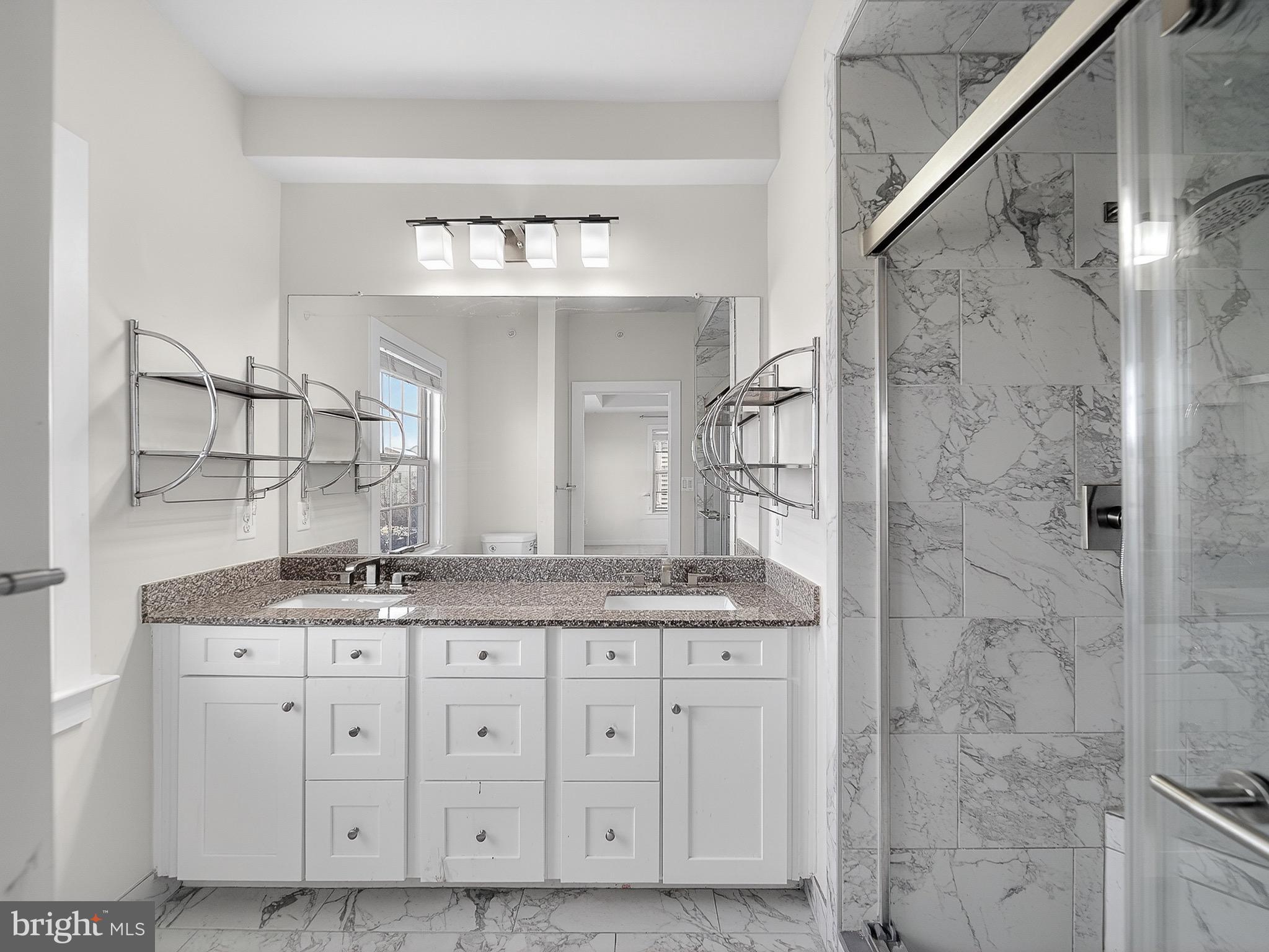 2914 Middleham Court Hanover, MD 21076 - Photo 30 of 50 a bathroom with a granite countertop sink a mirror and a shower