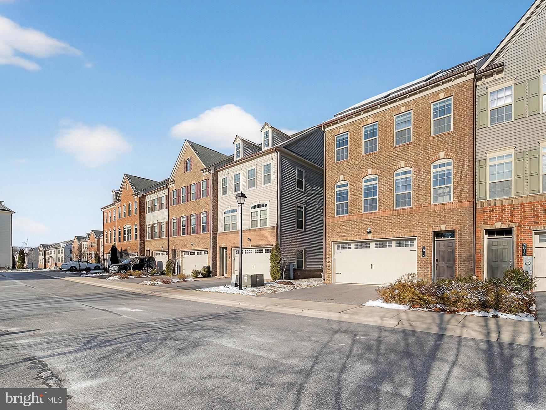 2914 Middleham Court Hanover, MD 21076 - Photo 3 of 50 a city street lined with buildings and a cars parked on the side of it