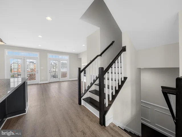 a view of entryway with wooden floor and stairs