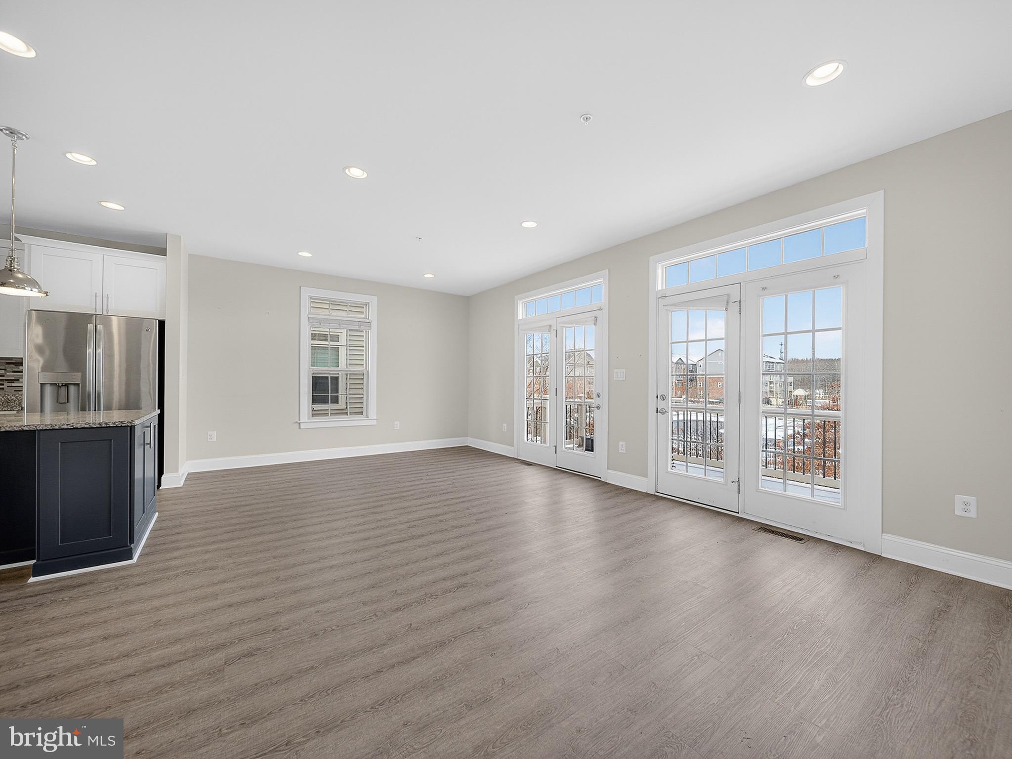 2914 Middleham Court Hanover, MD 21076 - Photo 6 of 50 a view of an empty room with wooden floor and a window