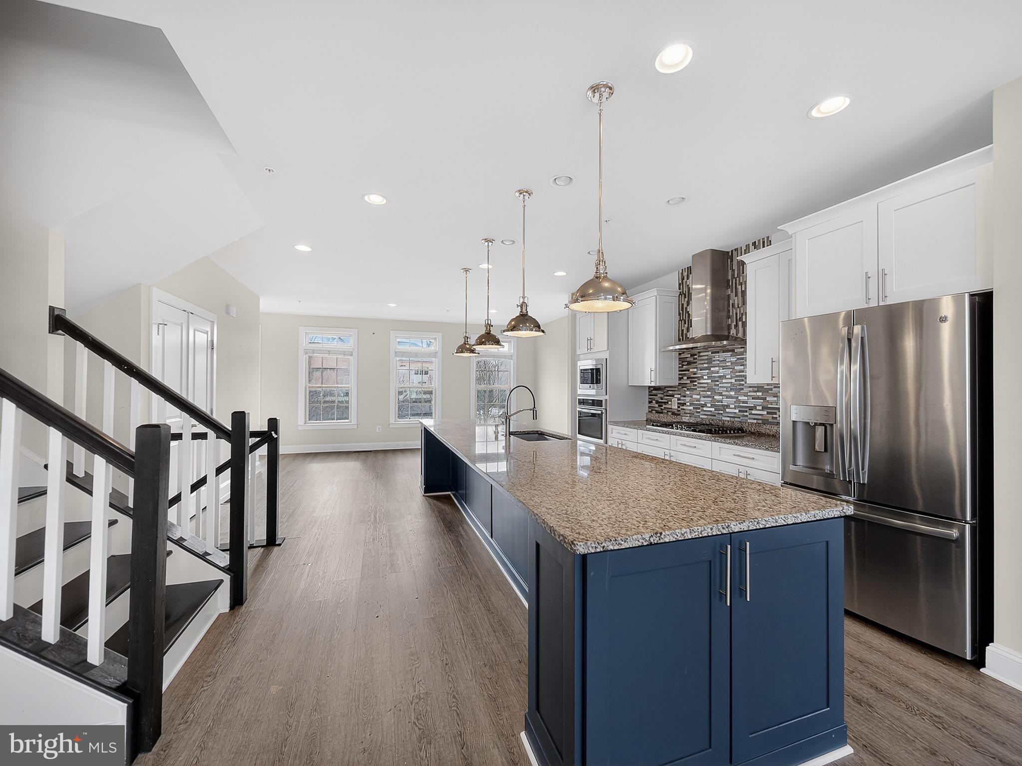 2914 Middleham Court Hanover, MD 21076 - Photo 7 of 50 a kitchen with stainless steel appliances granite countertop a refrigerator a oven and a wooden floors