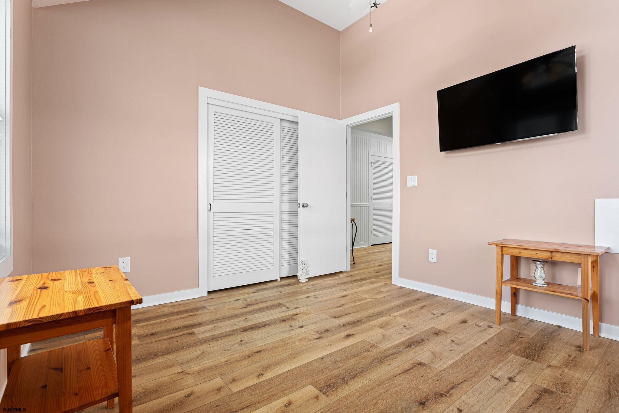 701 Lighthouse Road Cape May Point, NJ 08212 - Photo 13 of 32 a view of a livingroom with wooden floor and a flat screen tv