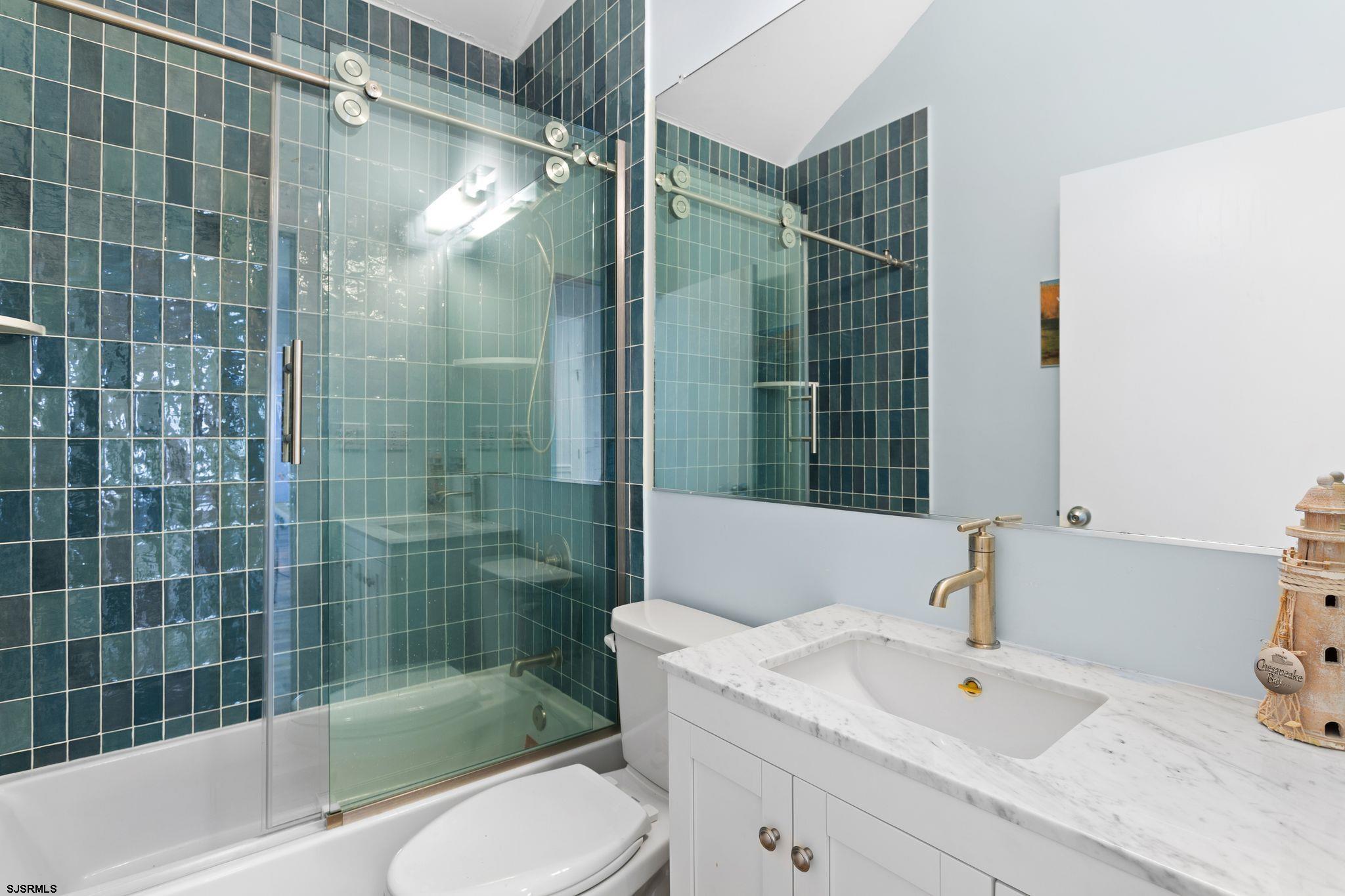 701 Lighthouse Road Cape May Point, NJ 08212 - Photo 14 of 32 a bathroom with a sink mirror toilet and bathtub