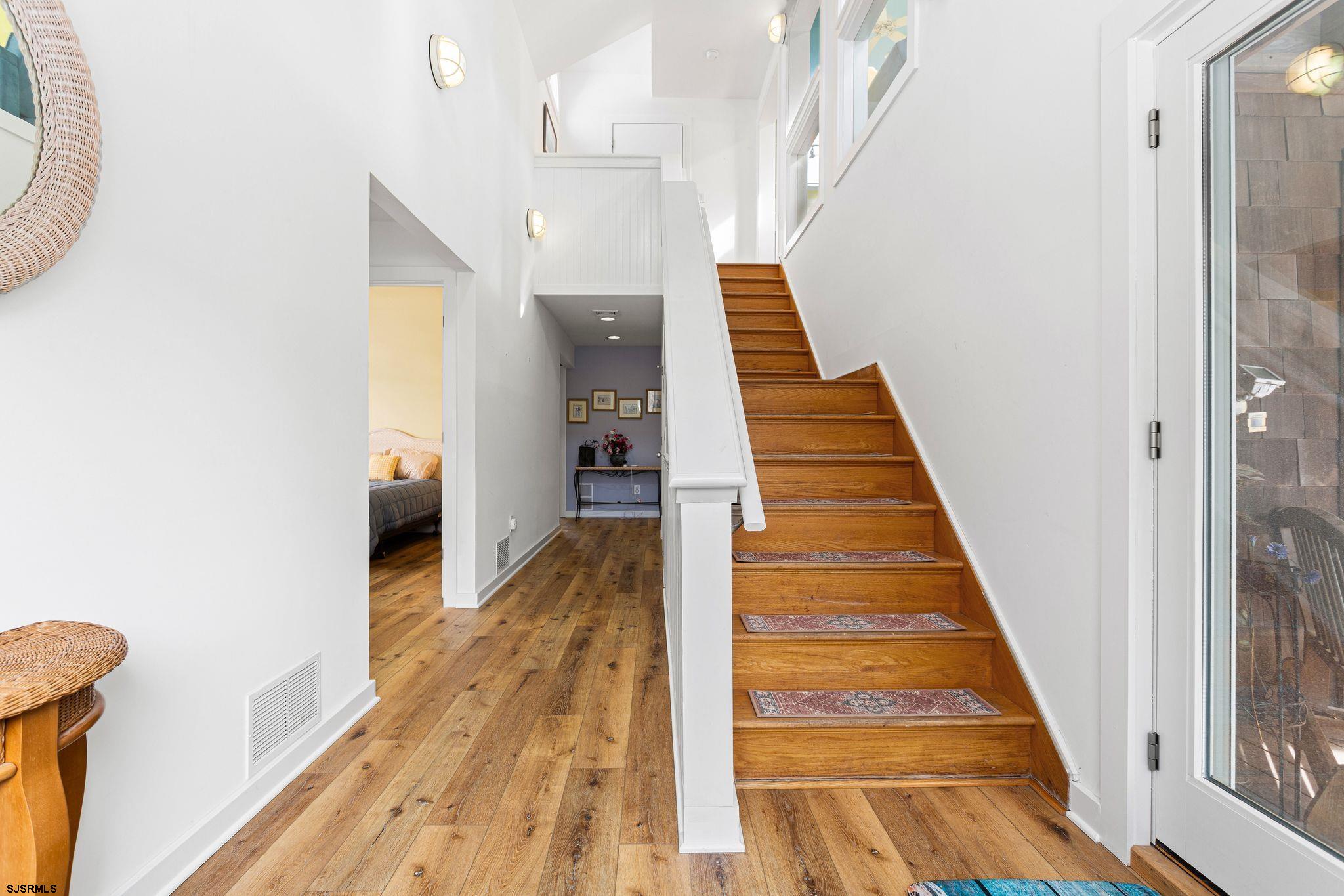 701 Lighthouse Road Cape May Point, NJ 08212 - Photo 16 of 32 a view of a hallway with wooden floor and staircase