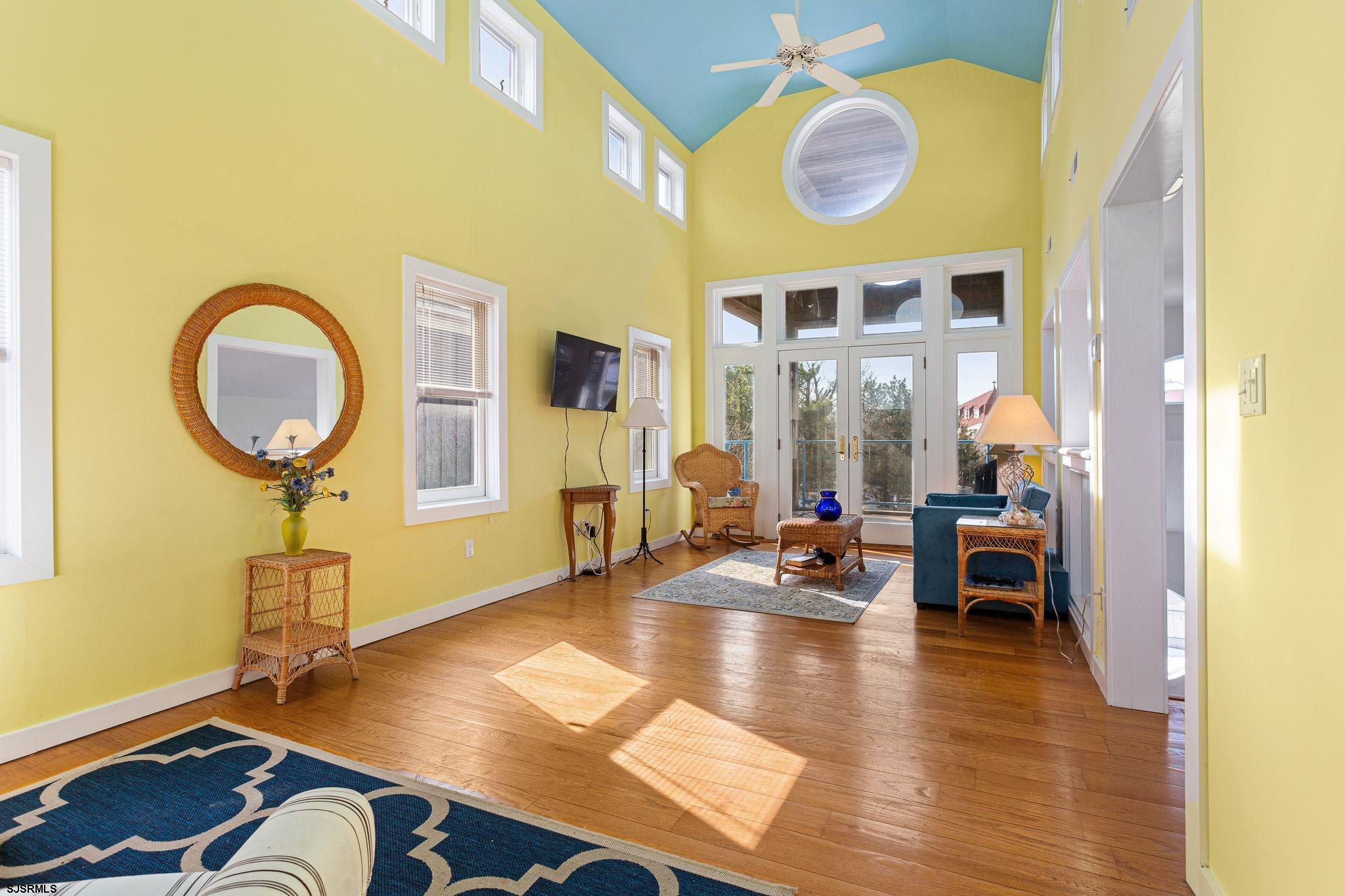 701 Lighthouse Road Cape May Point, NJ 08212 - Photo 18 of 32 a living room with furniture and a chandelier