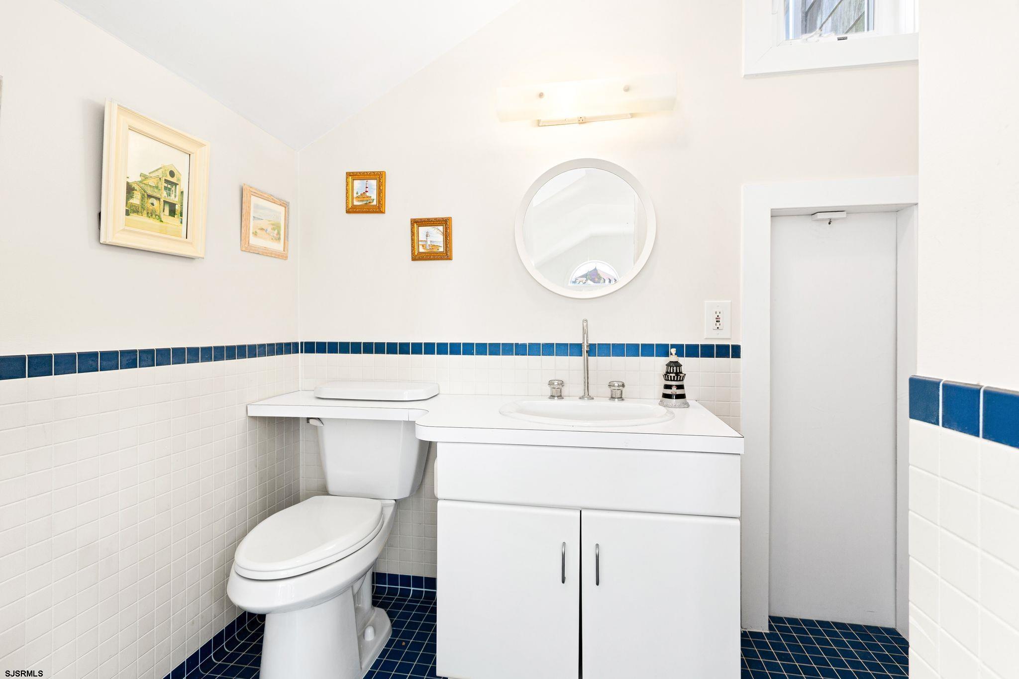 701 Lighthouse Road Cape May Point, NJ 08212 - Photo 25 of 32 a bathroom with a sink a toilet and a mirror