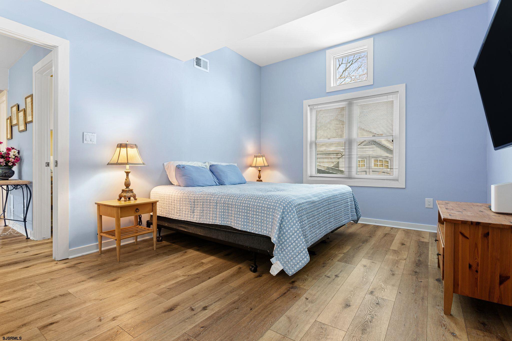 701 Lighthouse Road Cape May Point, NJ 08212 - Photo 5 of 32 a bedroom with a bed and wooden floor
