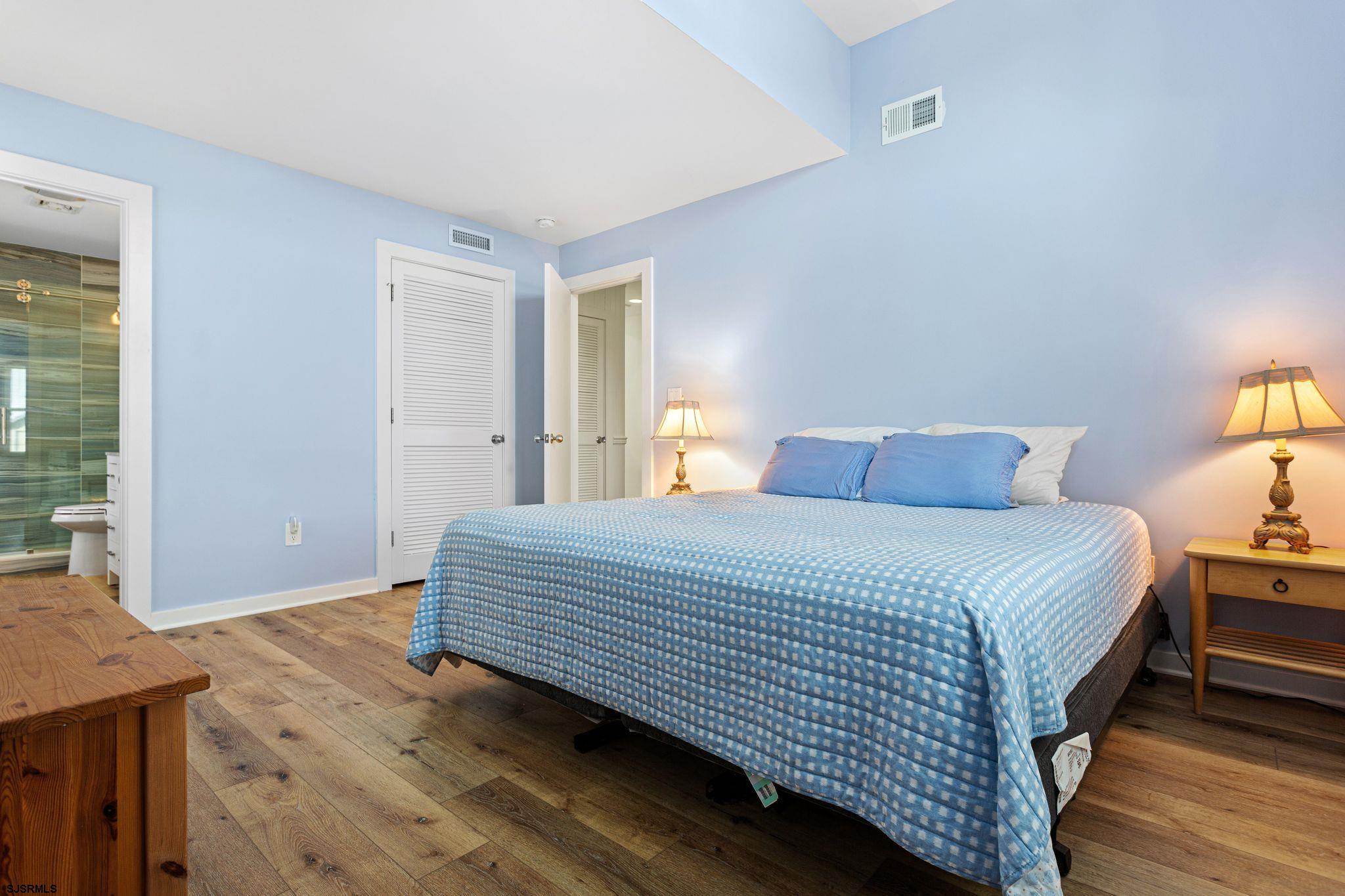 701 Lighthouse Road Cape May Point, NJ 08212 - Photo 6 of 32 a bedroom with a bed and wooden floor