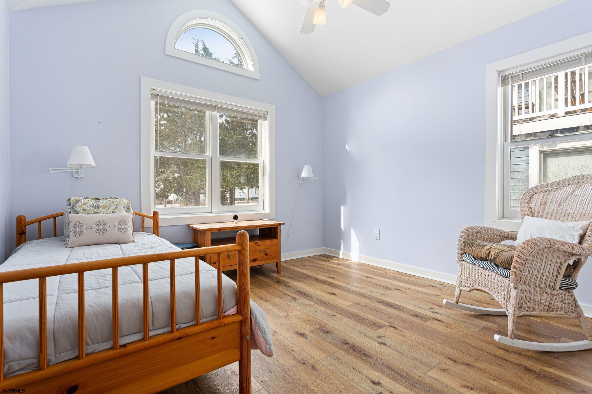 701 Lighthouse Road Cape May Point, NJ 08212 - Photo 8 of 32 a dining room with furniture a chandelier and wooden floor