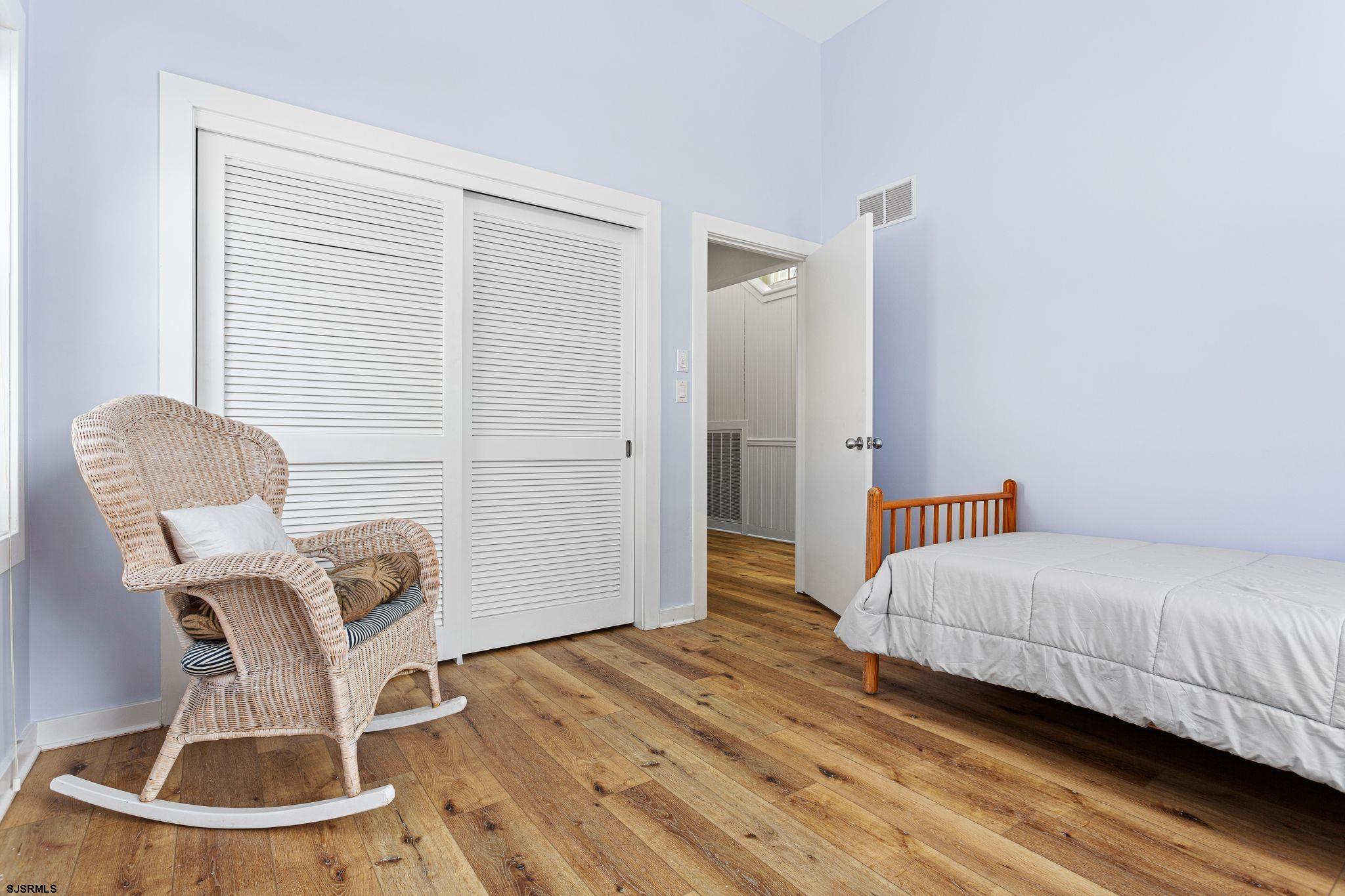 701 Lighthouse Road Cape May Point, NJ 08212 - Photo 9 of 32 a bedroom with a bed and wooden floor