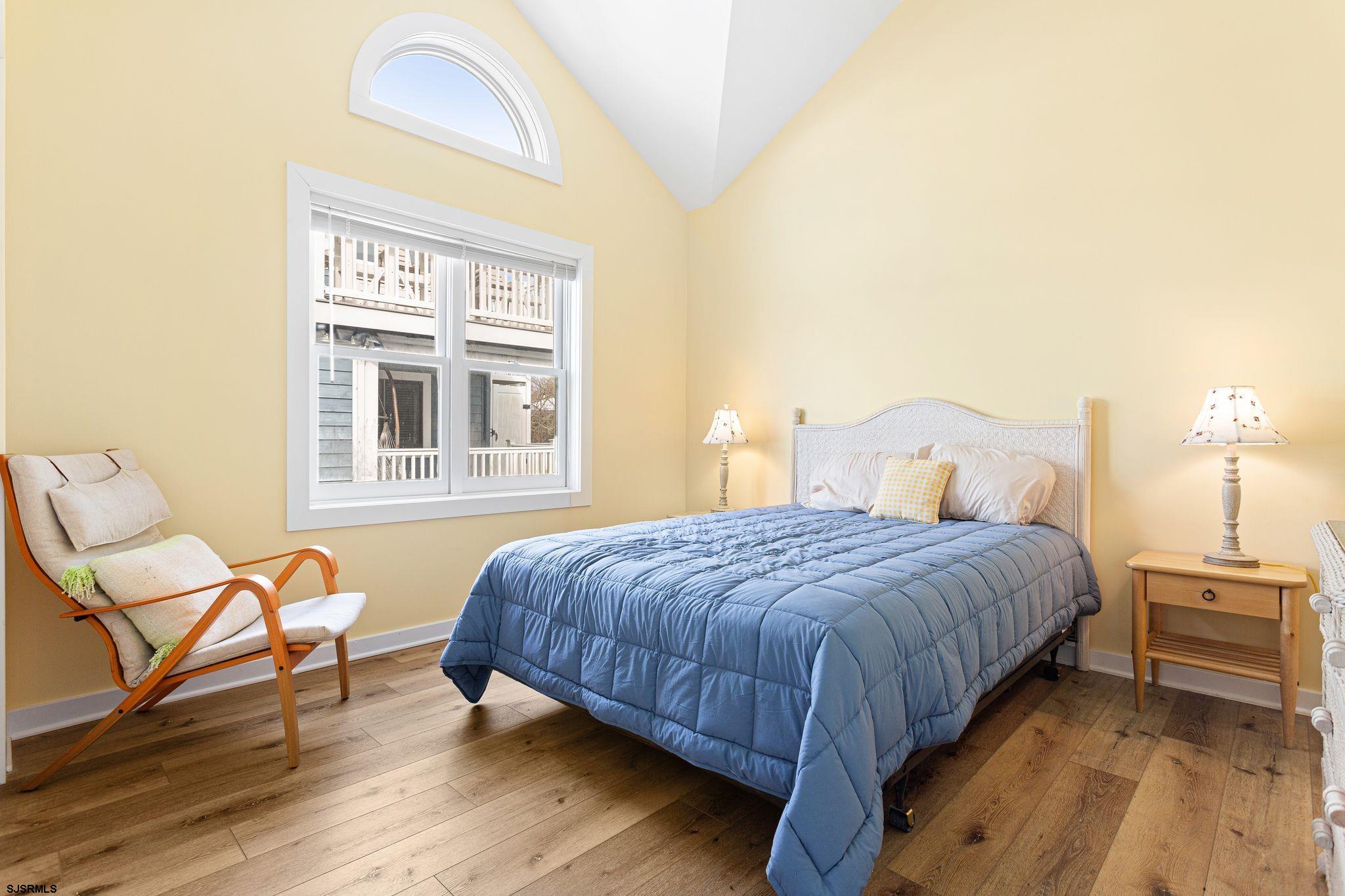 701 Lighthouse Road Cape May Point, NJ 08212 - Photo 10 of 32 a bedroom with a bed and wooden floor