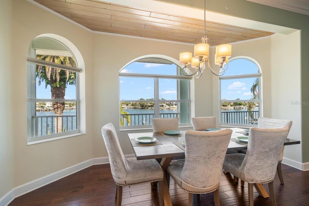 478 Harbor Drive South Indian Rocks Beach, FL 33785 - Photo 12 of 68 a dining room with furniture a chandelier and window