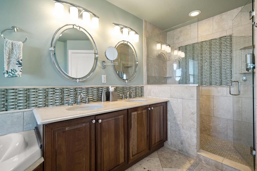 478 Harbor Drive South Indian Rocks Beach, FL 33785 - Photo 25 of 68 a bathroom with a double vanity sink and a mirror