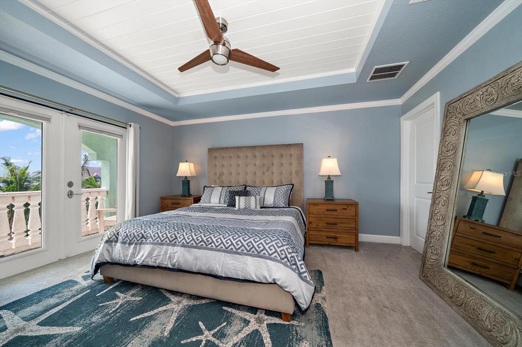 478 Harbor Drive South Indian Rocks Beach, FL 33785 - Photo 29 of 68 a bedroom with a bed and a chandelier