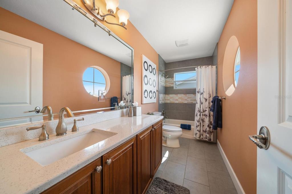 478 Harbor Drive South Indian Rocks Beach, FL 33785 - Photo 32 of 68 a bathroom with a double vanity sink and a mirror