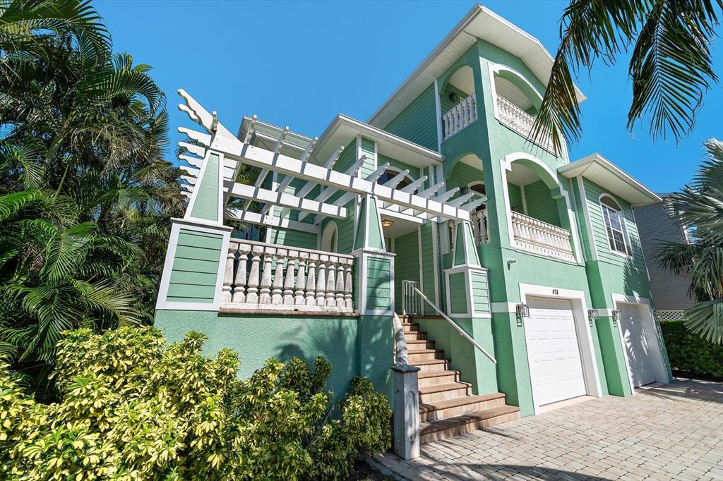 478 Harbor Drive South Indian Rocks Beach, FL 33785 - Photo 55 of 68 a view of a house with a small yard and potted plants