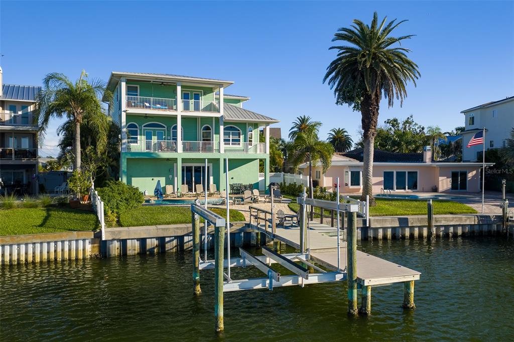 478 Harbor Drive South Indian Rocks Beach, FL 33785 - Photo 62 of 68 a view of swimming pool with lawn chairs and a yard
