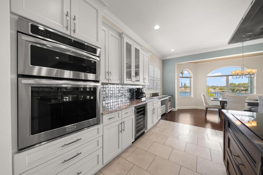 478 Harbor Drive South Indian Rocks Beach, FL 33785 - Photo 9 of 68 a kitchen with stainless steel appliances granite countertop a stove microwave and cabinets