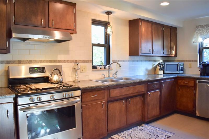 26 Robinhood Road Pittsburgh, PA 15220 - Photo 12 of 25 Imagine yourself cooking in this updated kitchen with new high end stainless steel appliances...they are all staying with the house. New granite, new back splash, new flooring, new lighting and a breakfast bar area for your morning coffee!