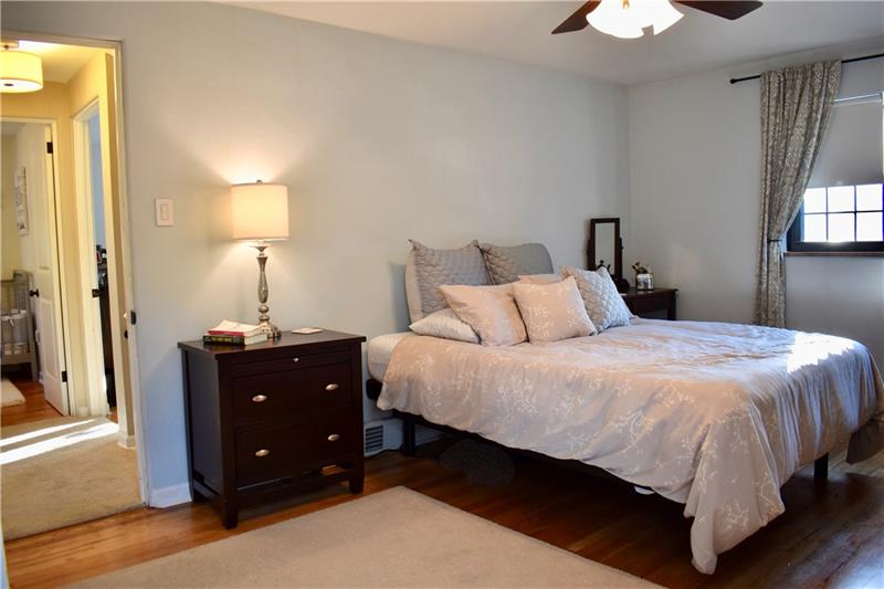 26 Robinhood Road Pittsburgh, PA 15220 - Photo 16 of 25 Second floor master bedroom! This spacious room offers gleaming hardwood flooring, neutral fresh paint, ceiling fan and a large custom walk-in closet.