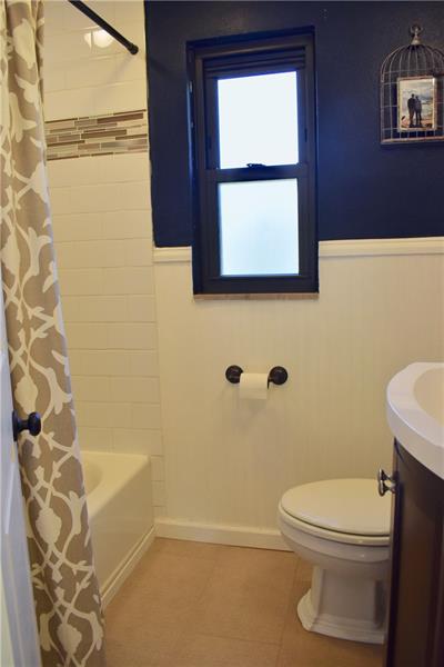 26 Robinhood Road Pittsburgh, PA 15220 - Photo 17 of 25 Second floor full bathroom...new tile flooring, new tile decorative designer shower surround, vanity, mirror, toilet and so much more!