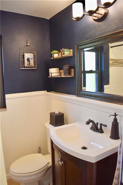 26 Robinhood Road Pittsburgh, PA 15220 - Photo 18 of 25 Second floor full bathroom...nicely updated with new flooring, vanity, sink, mirror, lighting, paint and tile shower surround.
