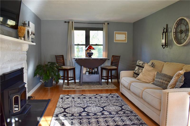 26 Robinhood Road Pittsburgh, PA 15220 - Photo 5 of 25 Enjoy this charming living room with gleaming hardwood flooring, neutral paint, new tile around the the mantle and hearth.