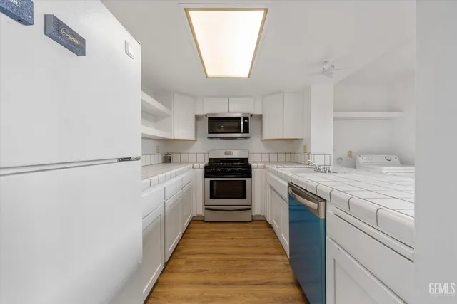 a kitchen with granite countertop a sink and a stove top oven