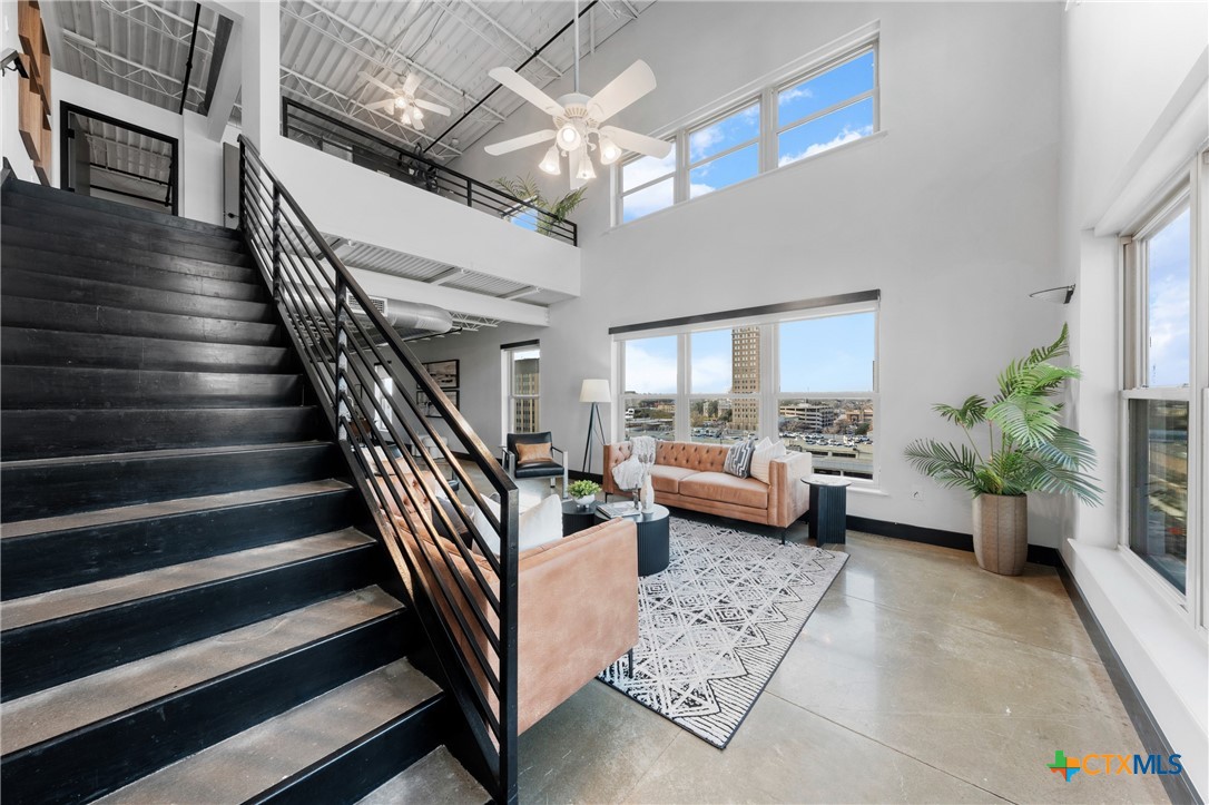 219 South 4th Street, Unit 608 Waco, TX 76701 - Photo 16 of 42 a living room with furniture and a chandelier