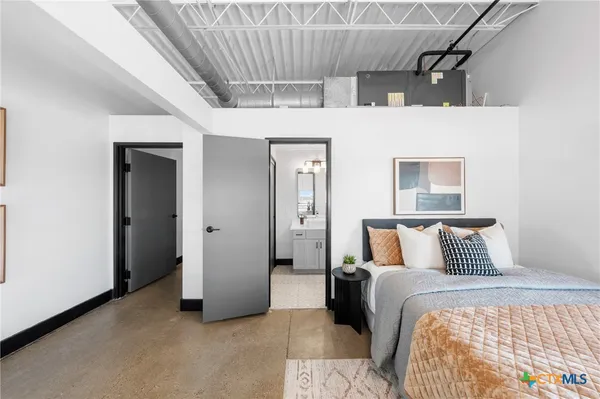 a bathroom with a sink a toilet a mirror and shower