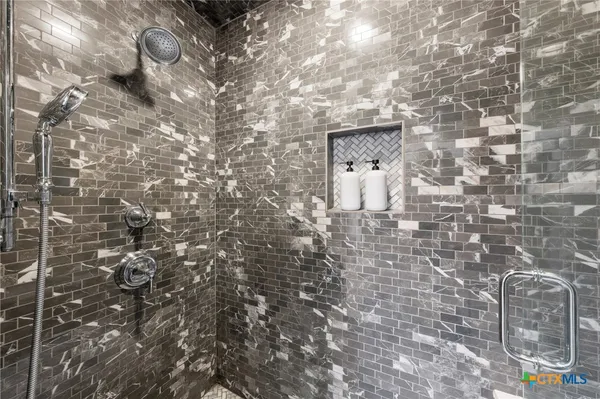 a bedroom with bed and cabinets