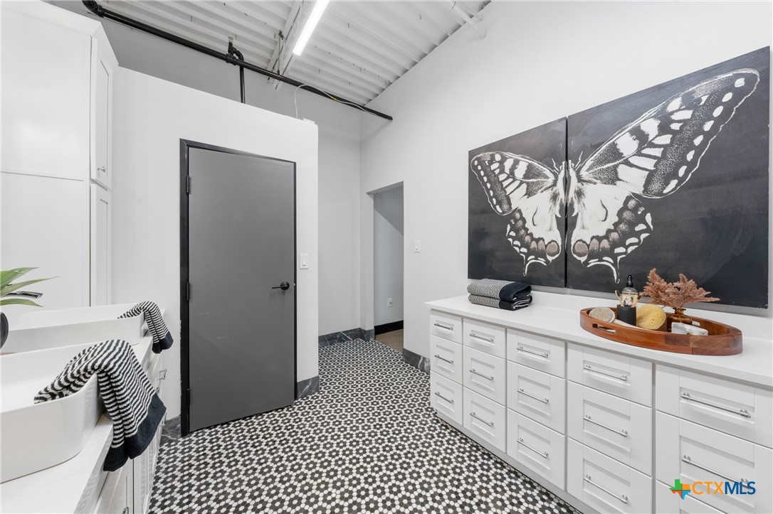 219 South 4th Street, Unit 608 Waco, TX 76701 - Photo 31 of 42 a bedroom with bed and cabinets