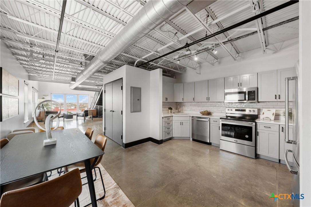219 South 4th Street, Unit 608 Waco, TX 76701 - Photo 7 of 42 a kitchen with stove a sink and cabinets