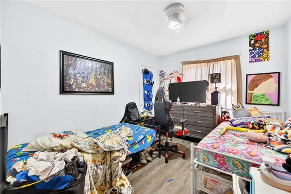 a bedroom with furniture and a flat screen tv