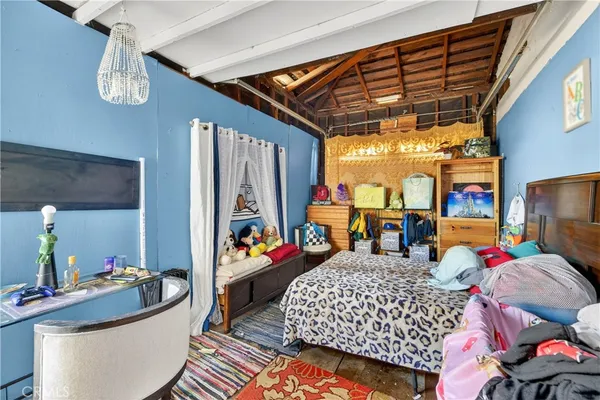 a bed room with furniture and a flat screen tv