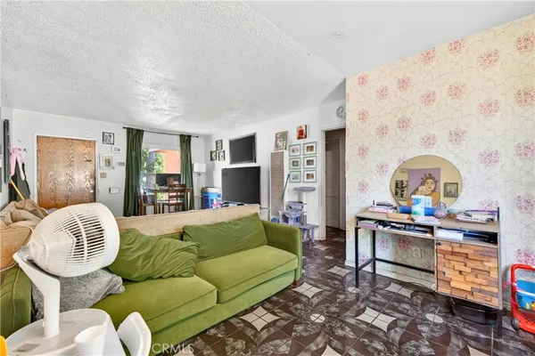 a living room with furniture and a painting on the wall