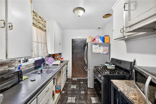 a kitchen with stainless steel appliances granite countertop a stove and a refrigerator
