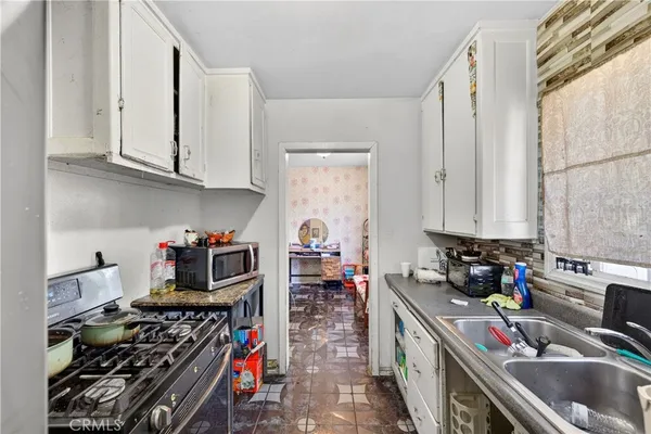 a kitchen with lots of appliances and a sink