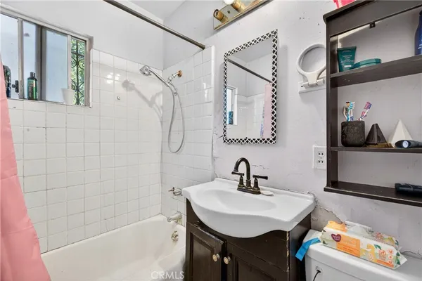 a bathroom with a bathtub a sink and a mirror